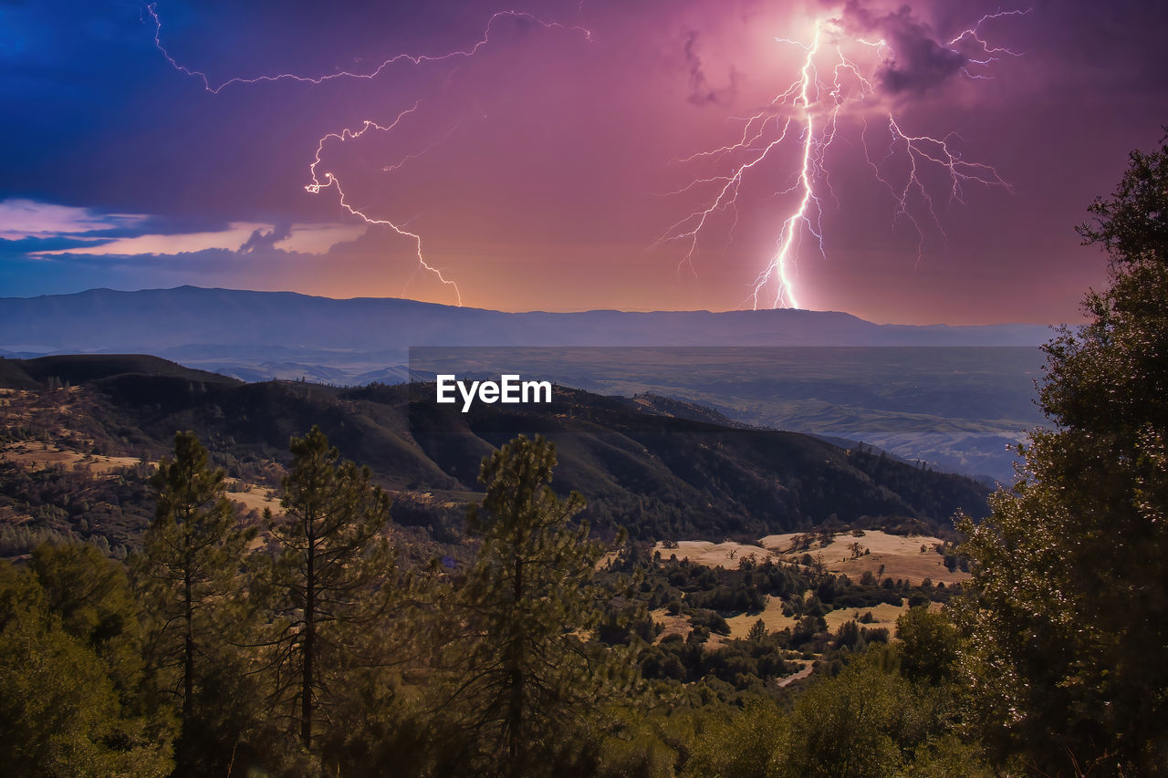 SCENIC VIEW OF LIGHTNING OVER MOUNTAIN