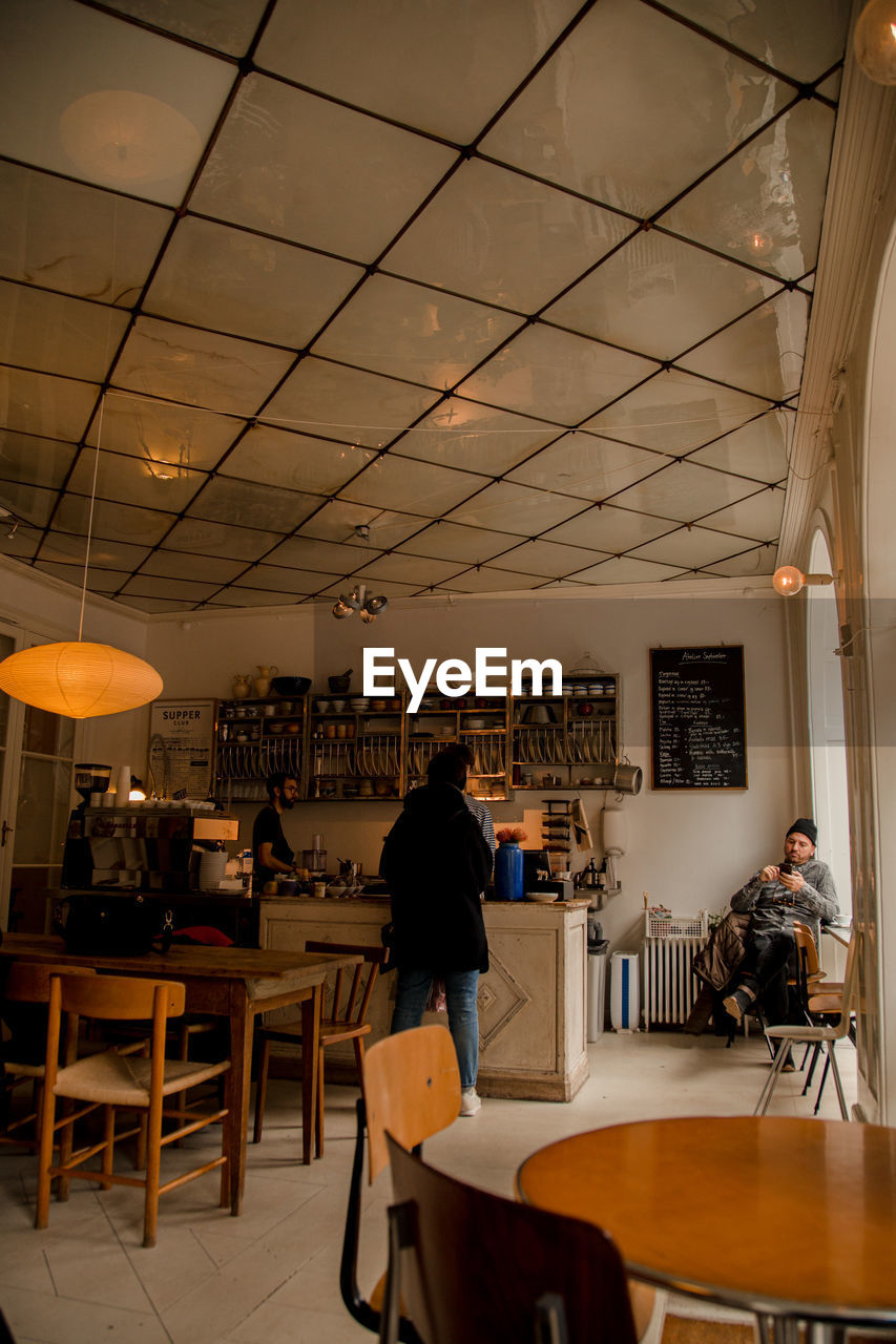 PEOPLE SITTING IN CAFE