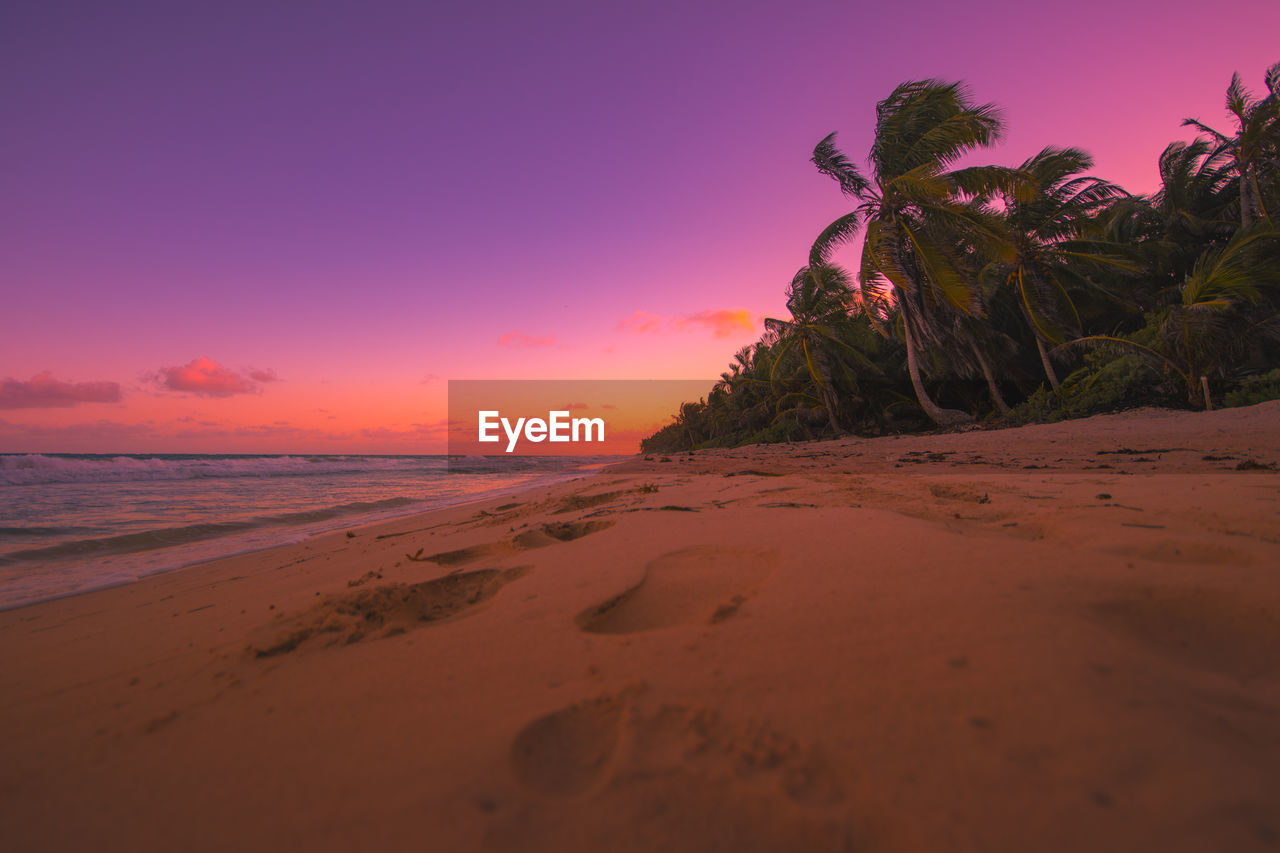 Scenic view of beach against sky during sunset