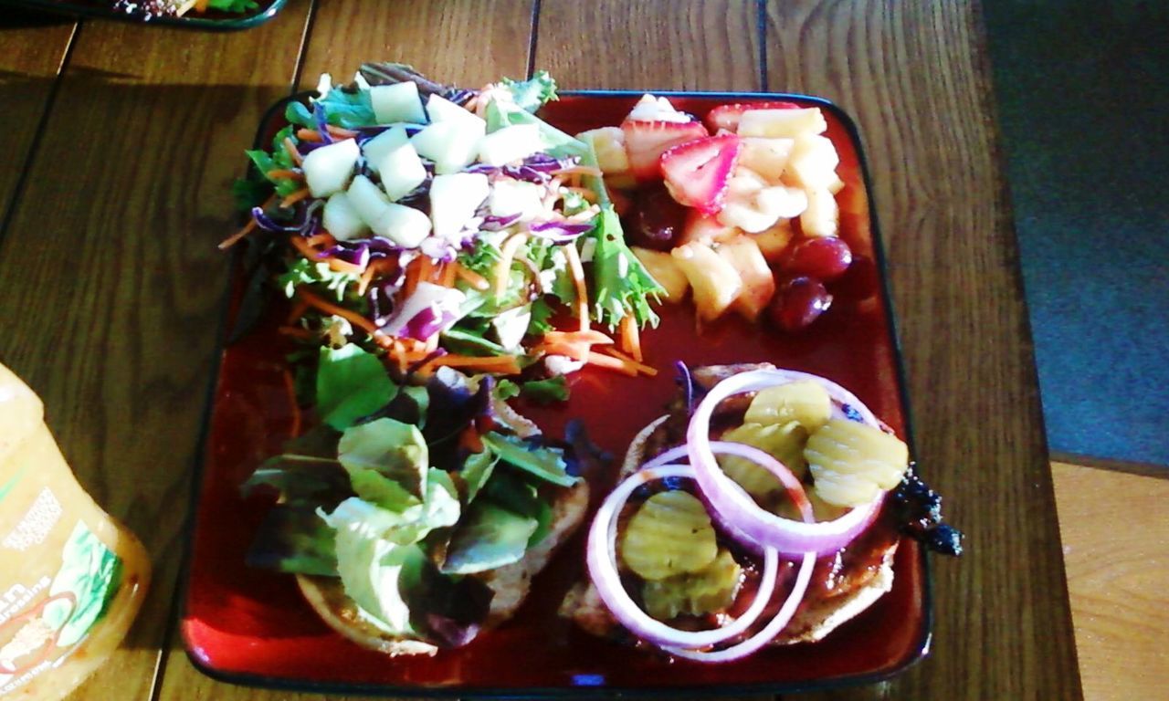 High angle view of salad and chopped fruits in plate on table