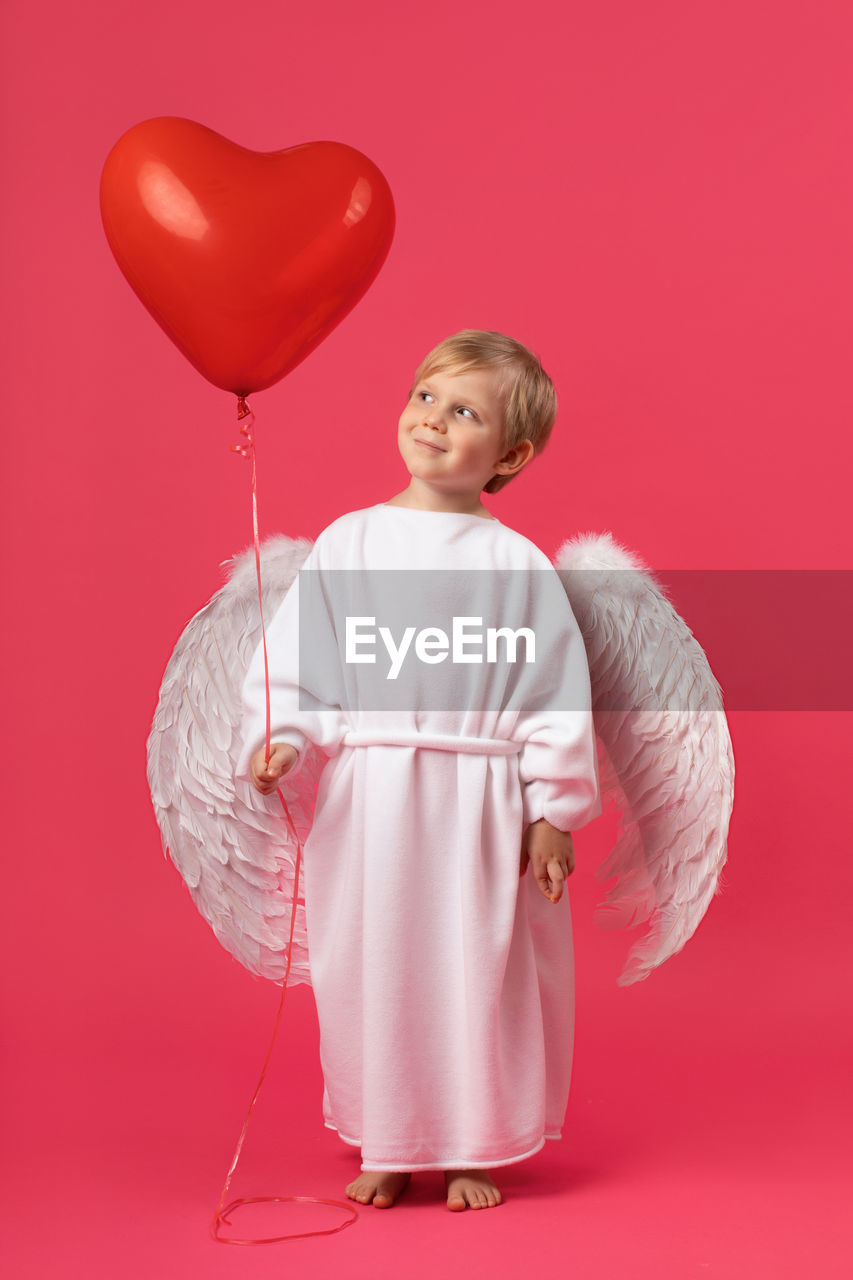 GIRL HOLDING BALLOONS
