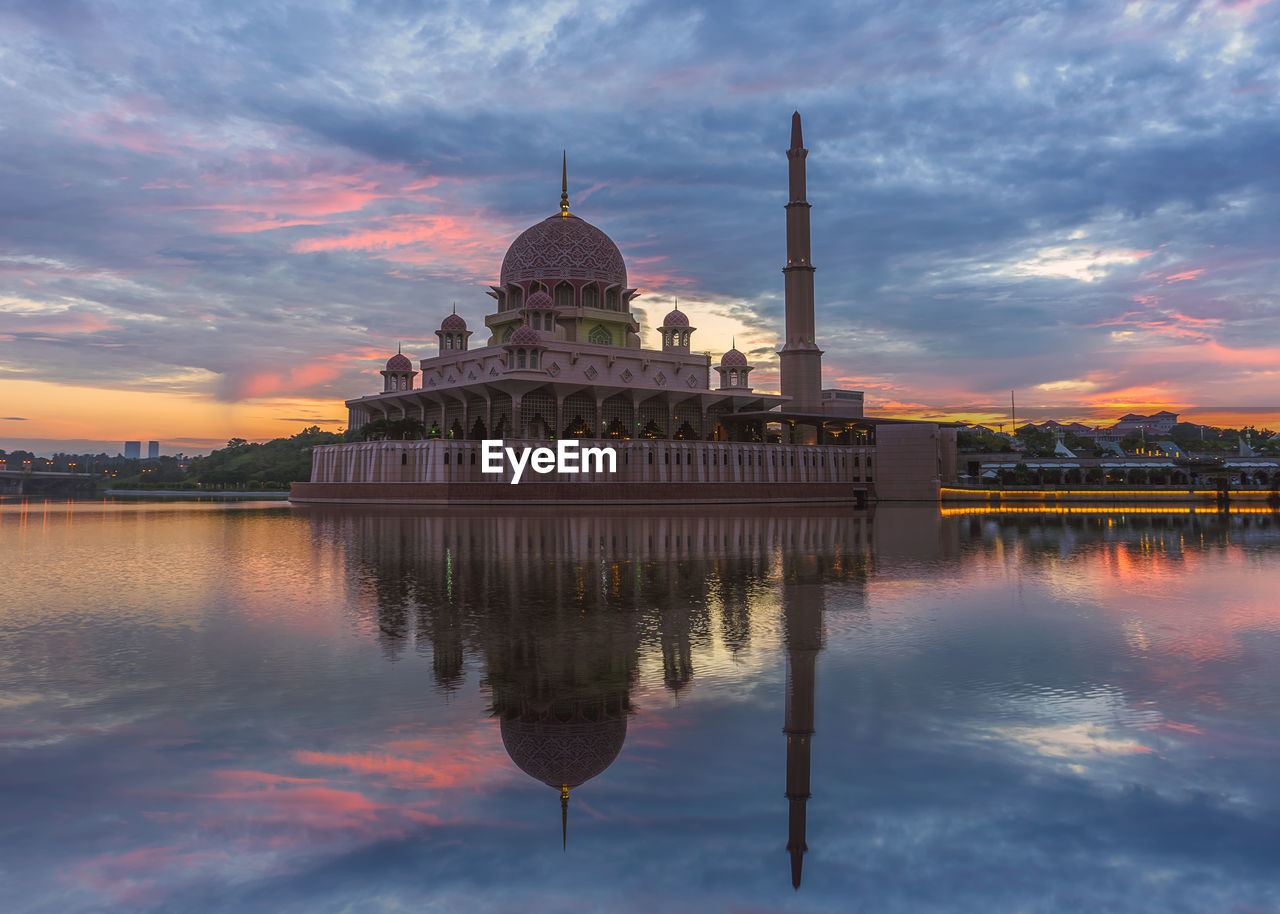 Reflection of mosque on reflecting pool during sunset