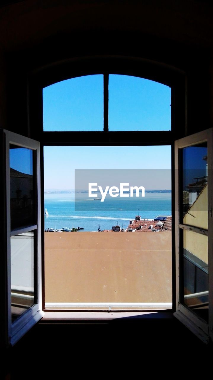 Close-up of sea seen through window