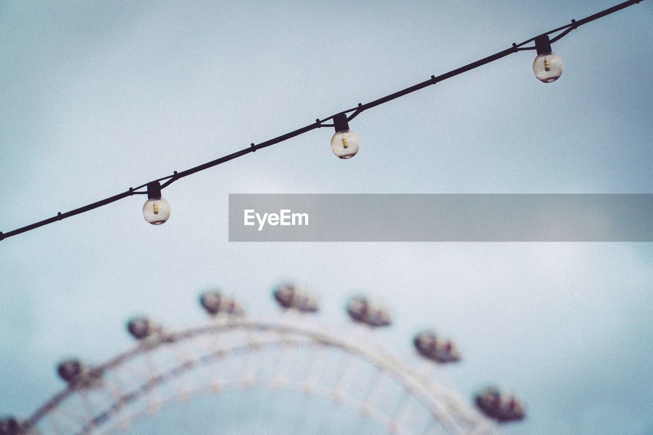 LOW ANGLE VIEW OF HANGING AGAINST SKY