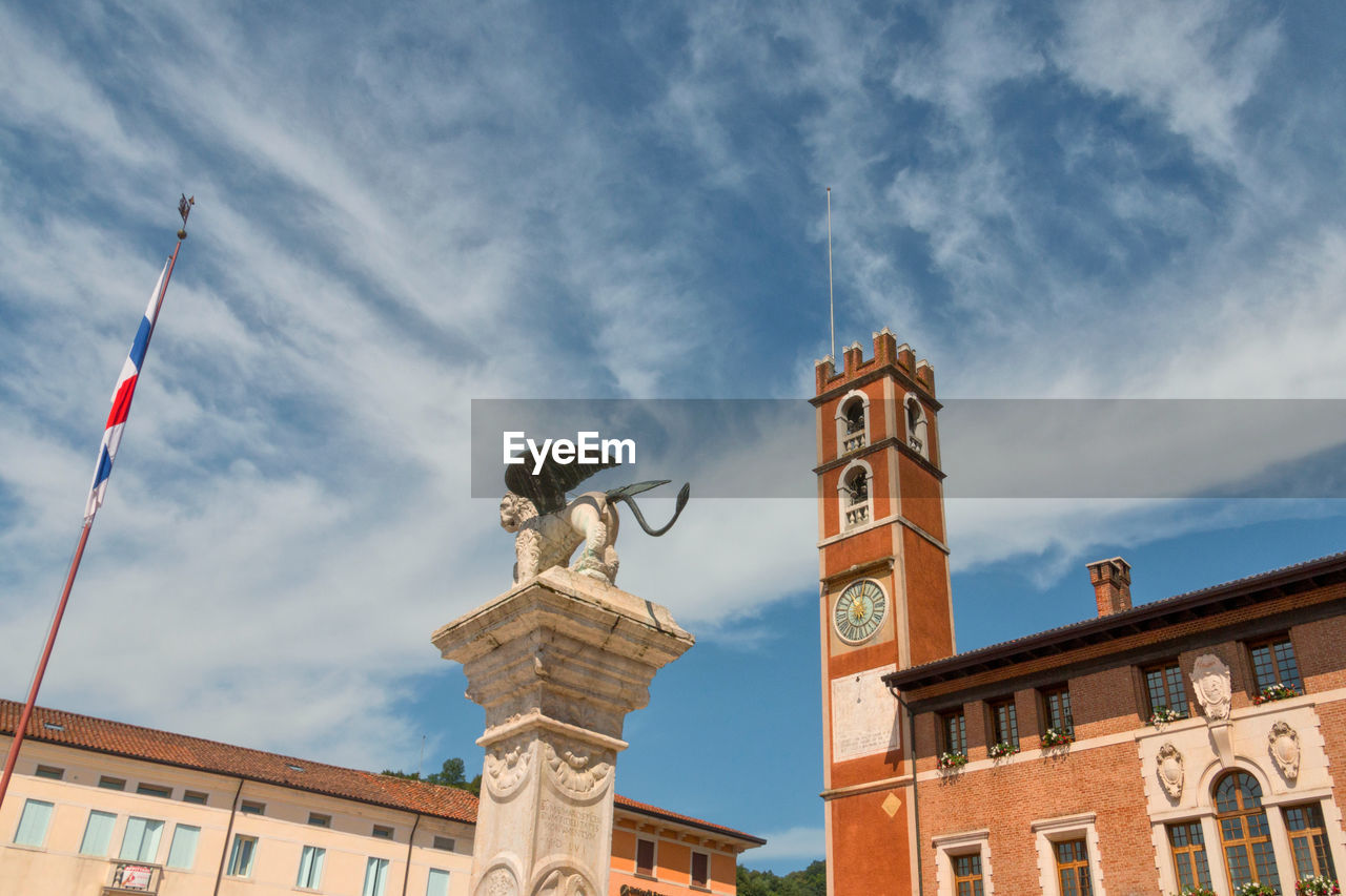 LOW ANGLE VIEW OF STATUE AGAINST SKY AND BUILDINGS