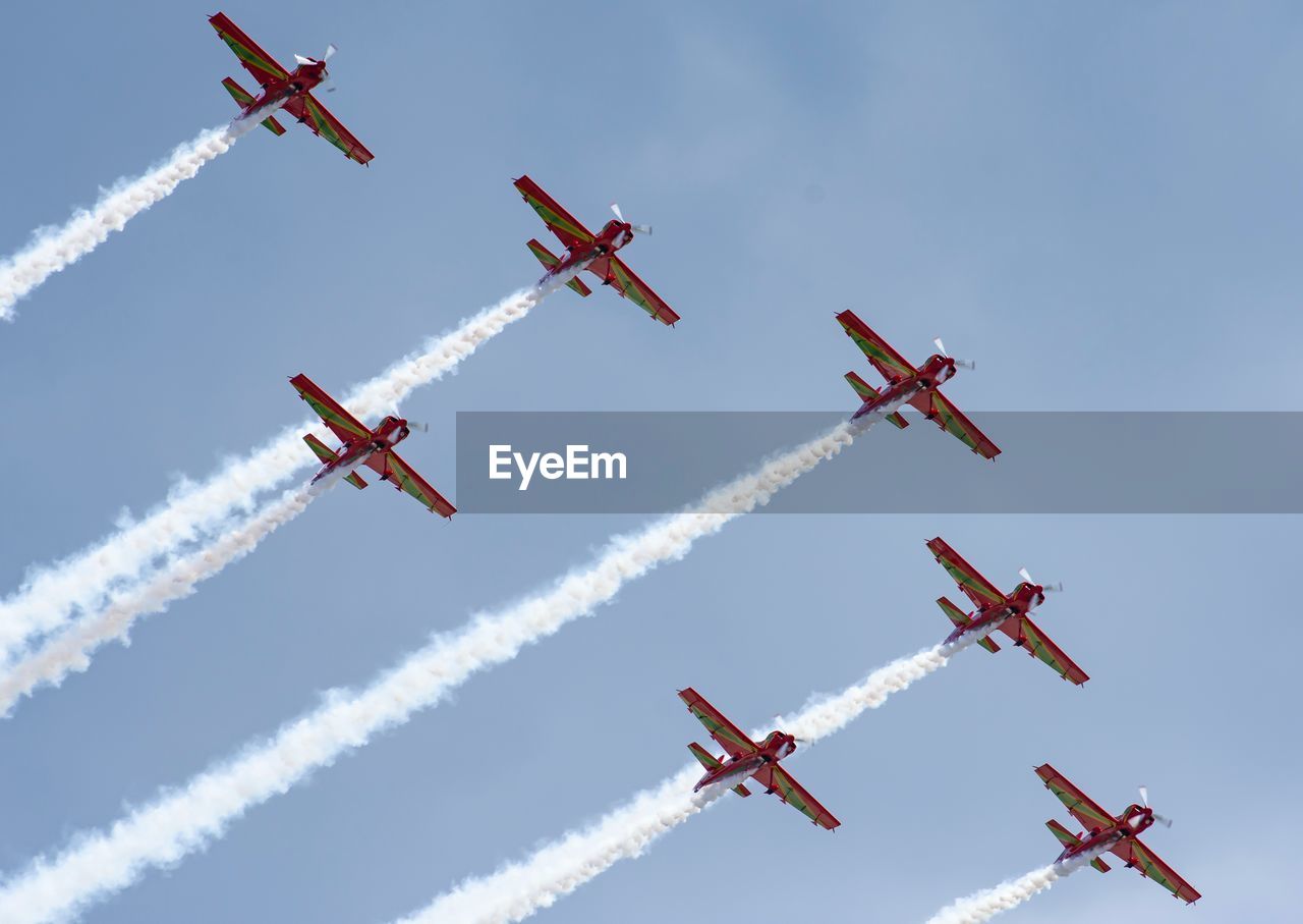 low angle view of airshow against sky