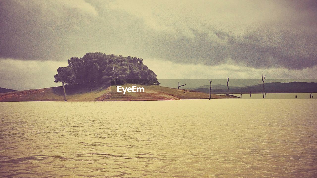 SCENIC VIEW OF MOUNTAINS AGAINST CLOUDY SKY