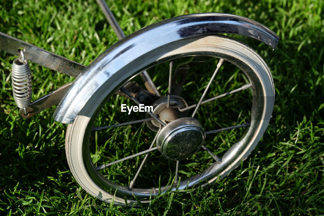 CLOSE-UP OF WHEEL AND TREES