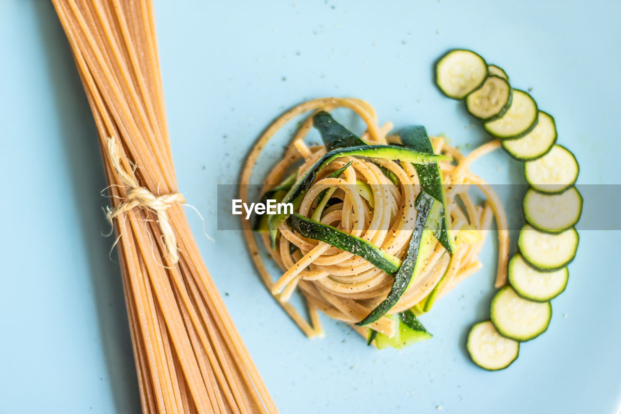 Close-up of spaghetti and zucchini on table