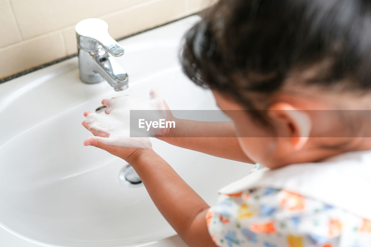 high angle view of girl washing hands