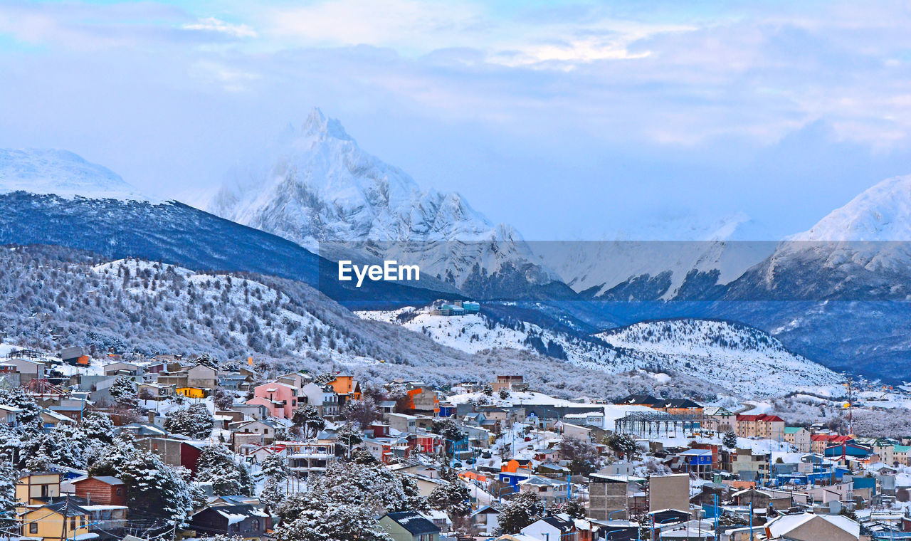 High angle view of townscape and mountains against sky