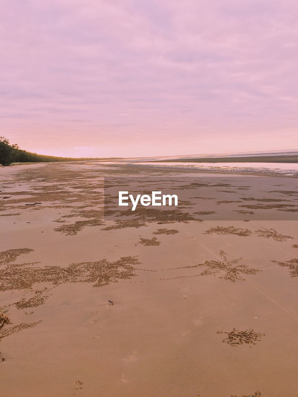 Scenic view of beach against sky during sunset