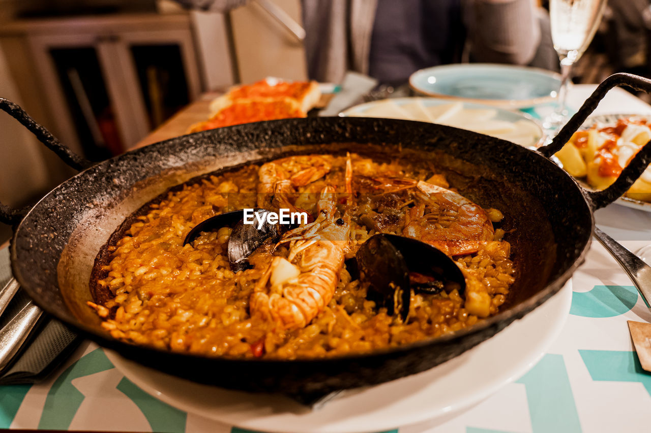 Paella, the traditional dish in spain. cast iron with seafood paella. rice with prawns, mussels