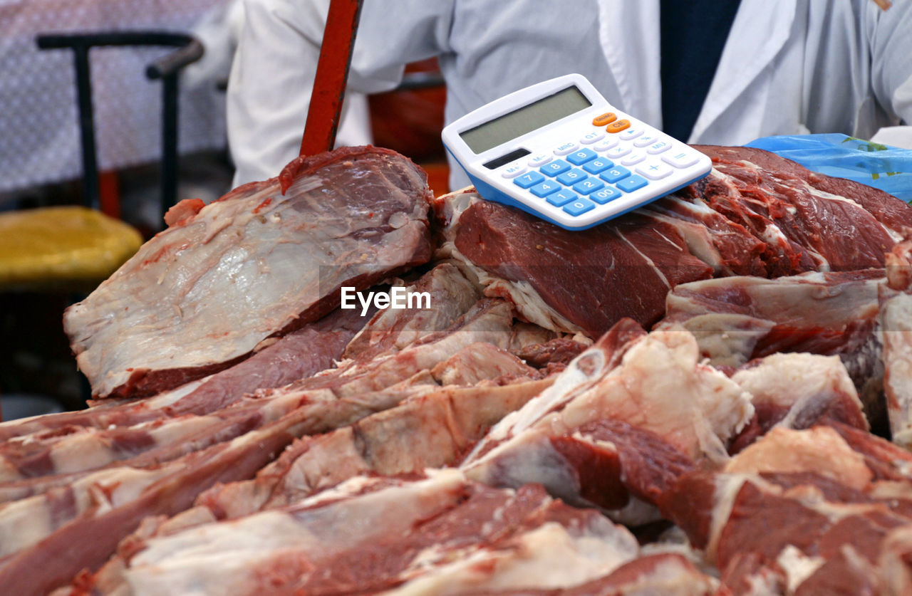 Calculator placed directly on the meat in the green bazaar in almaty, kazakhstan