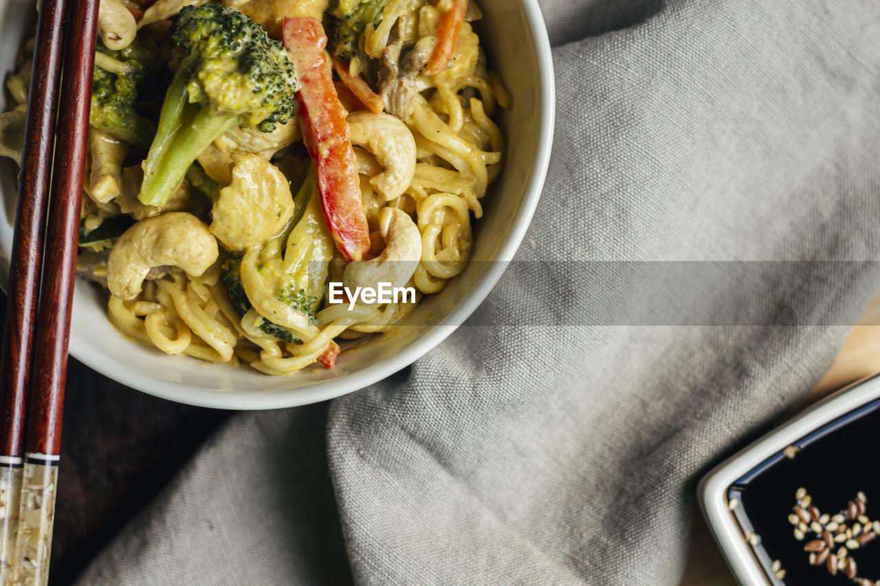 Yellow curry noodles with vegetables and cashews