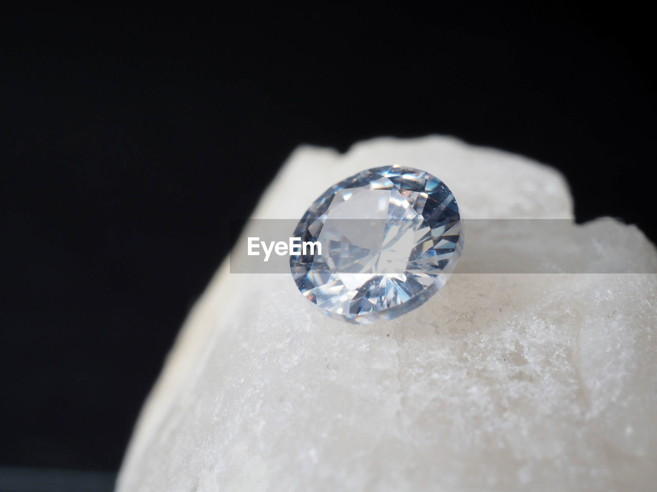 Close up shoot of shiny diamonds. shoot on a black textured background