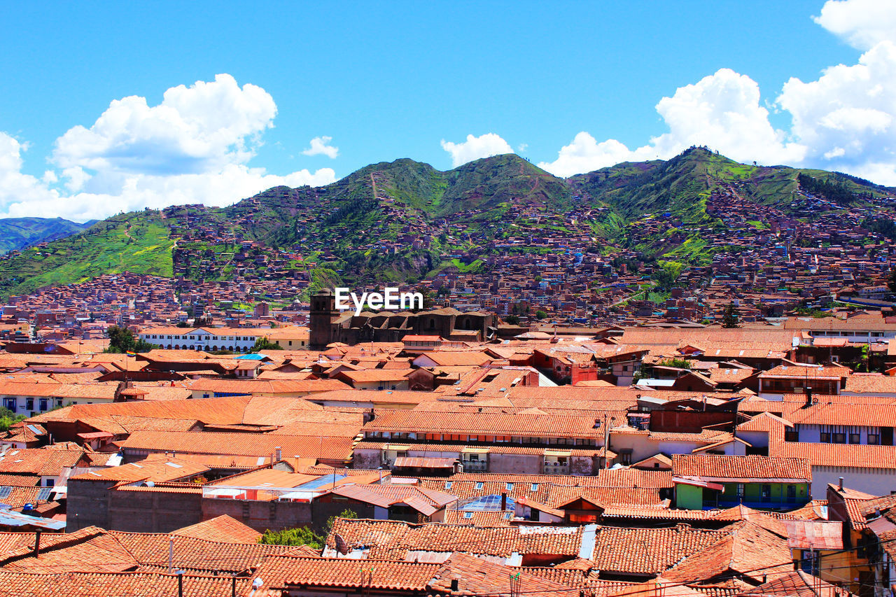 Townscape by mountains against sky