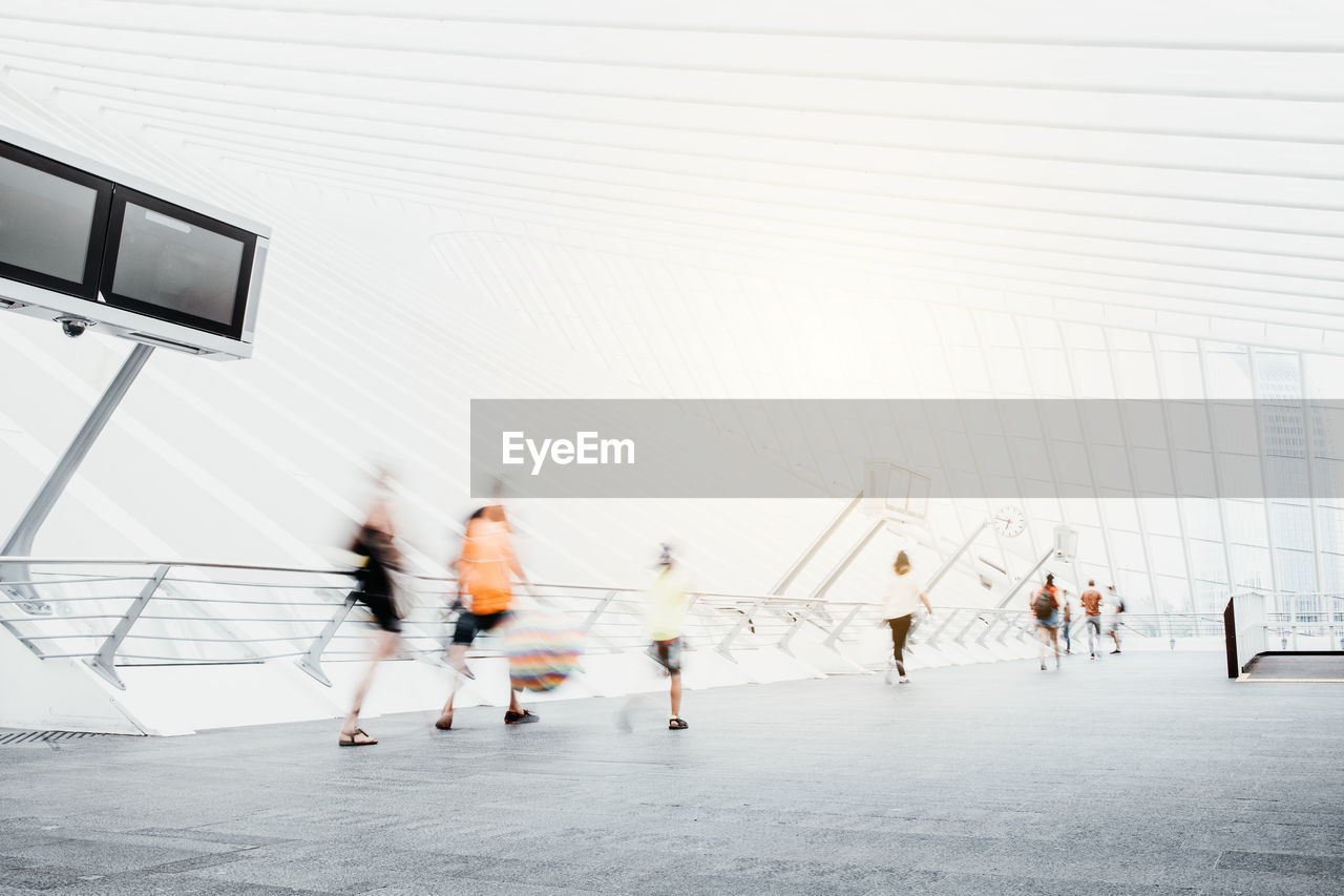 Blurred motion of people walking on road