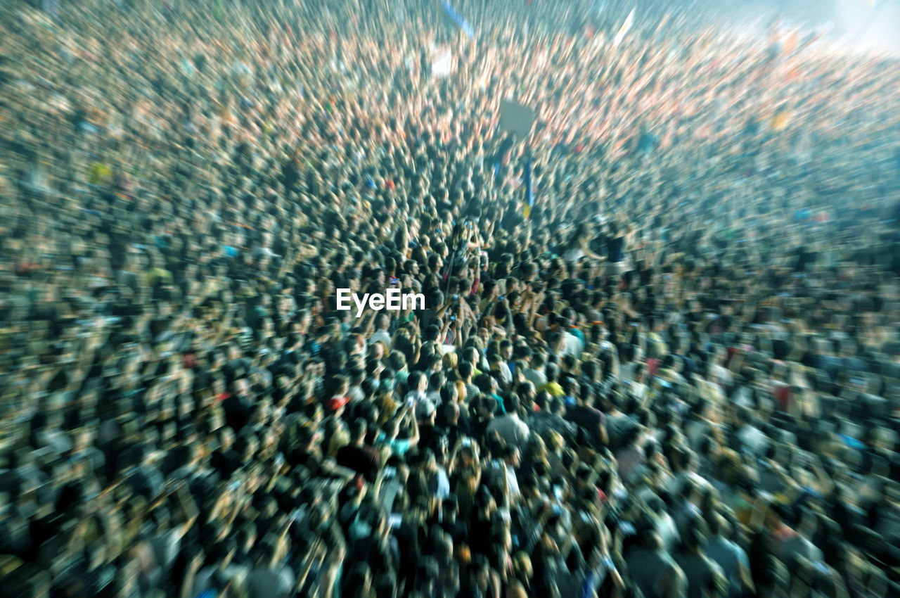 Blurred crowd partying at a music festival. zoom in effect