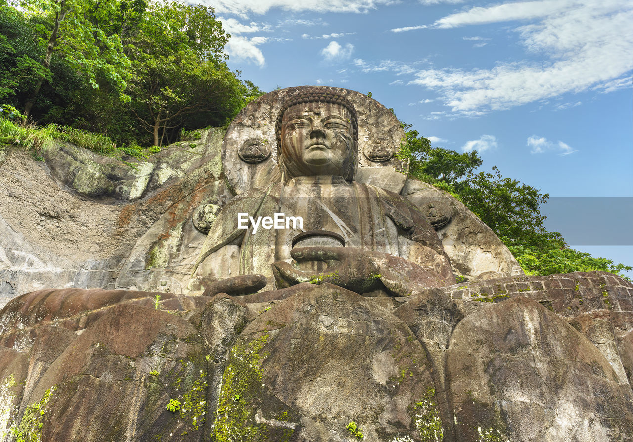 Giant buddha daibutsu of nihonji temple on the mountain sides of mount nokogiri stone quarry.