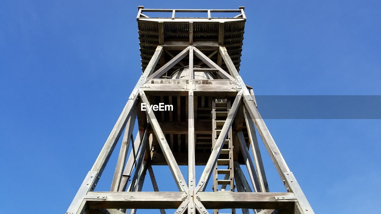 Low angle view of tower against clear blue sky