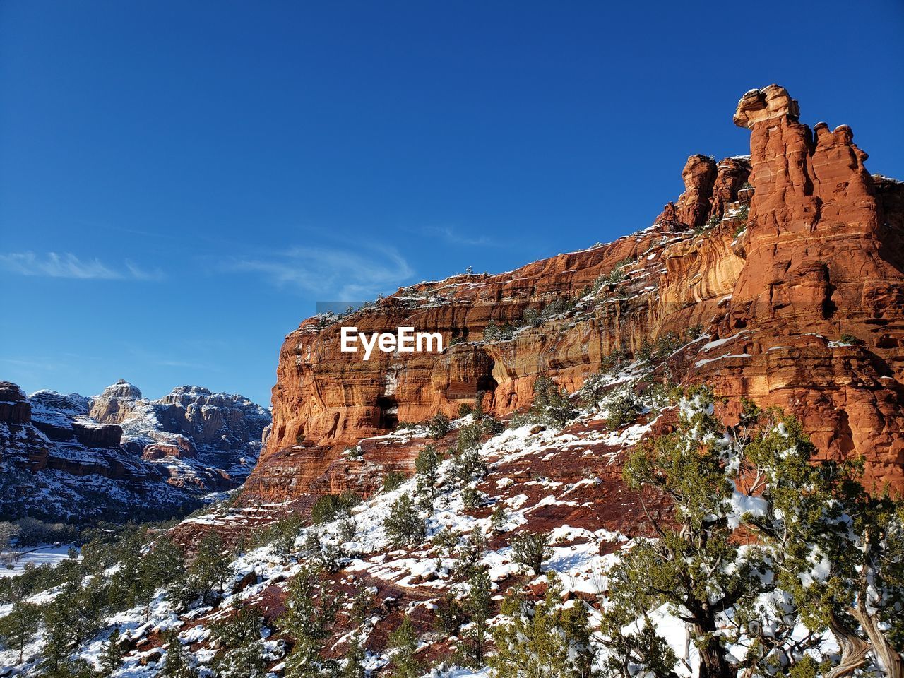 LOW ANGLE VIEW OF ROCKS ON MOUNTAIN