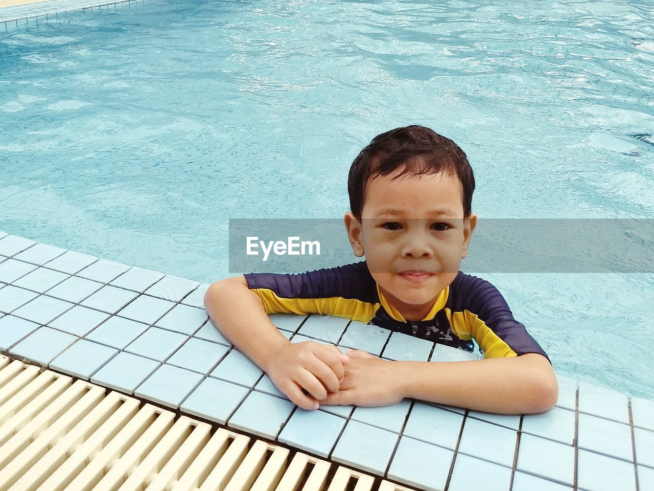 Portrait of boy swimming in pool