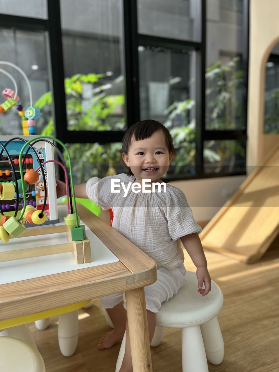 Portrait of girl is sitting on table