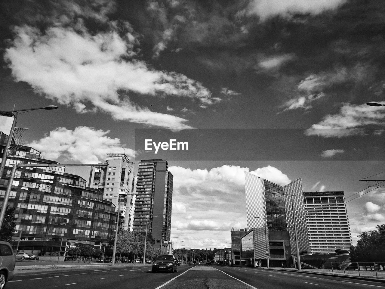 STREET AMIDST BUILDINGS AGAINST SKY