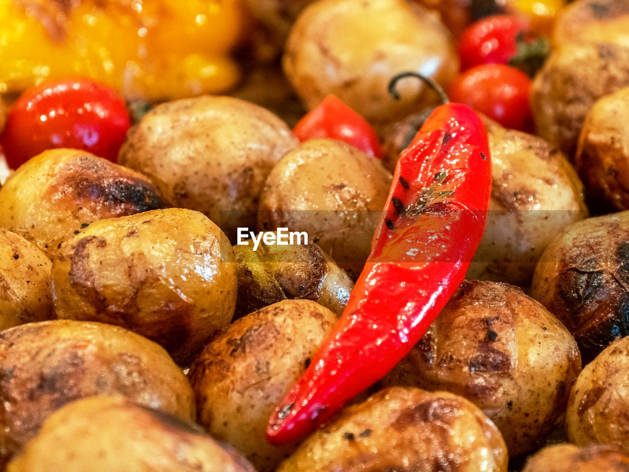 Roasted red pepper lies on the baked potat, close up. grilled food. festival of street food. 