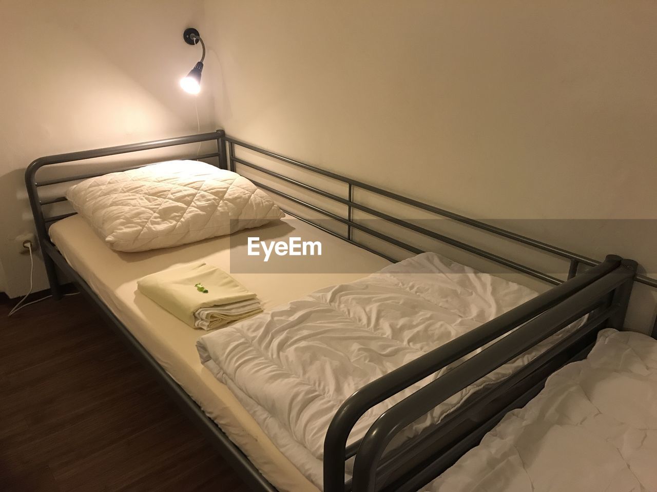 bed, bedroom, indoors, furniture, room, domestic room, bed frame, pillow, home interior, linen, lighting equipment, no people, sheet, electric lamp, floor, hotel room, night table, relaxation, architecture, house, duvet, bed sheet, wealth, comfortable