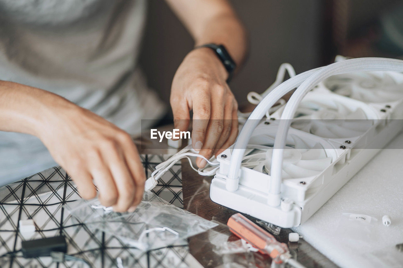 Person engaged in assembling or working on computer hardware, involving precise technical work 