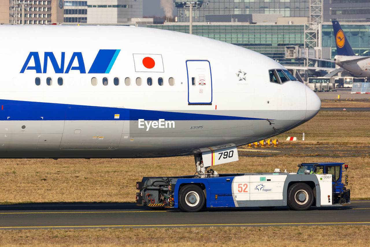 AIRPLANE AT AIRPORT RUNWAY