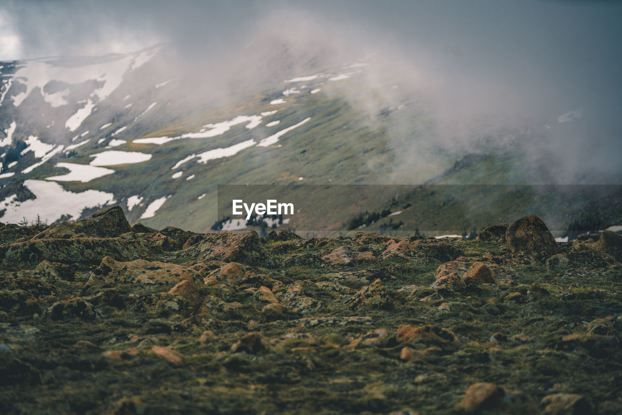 Snow capped mountains, rocky mountains, rocks.