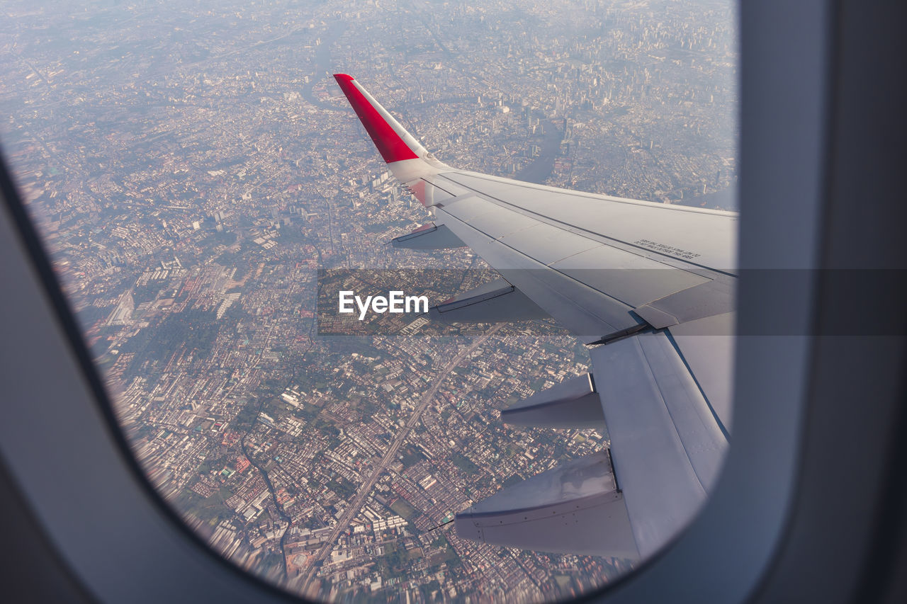 Looking through window wing of an airplane