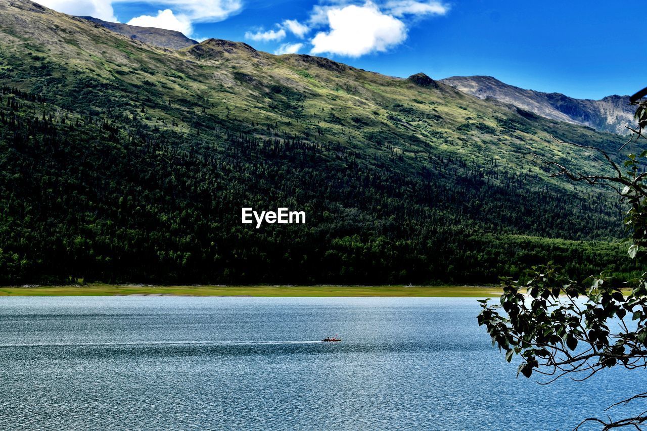SCENIC VIEW OF LAKE BY TREE MOUNTAINS AGAINST SKY
