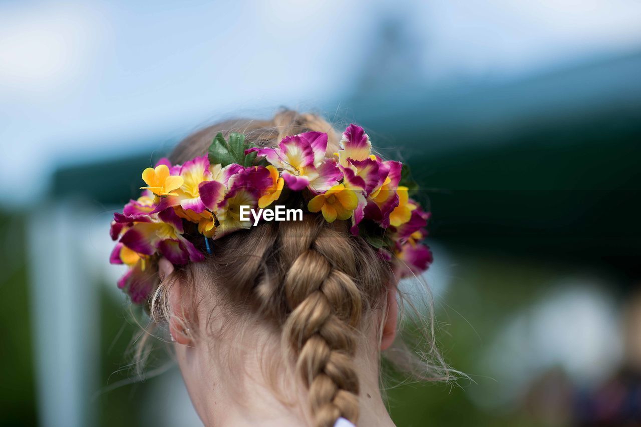 Rear view of woman wearing flowers 