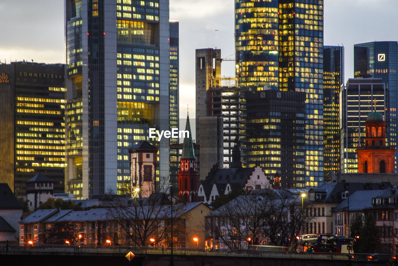 ILLUMINATED CITYSCAPE AGAINST SKY