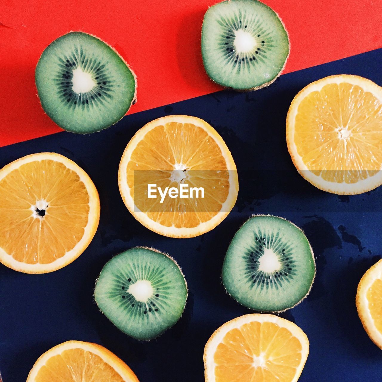 Directly above shot of halved limes and kiwis on table