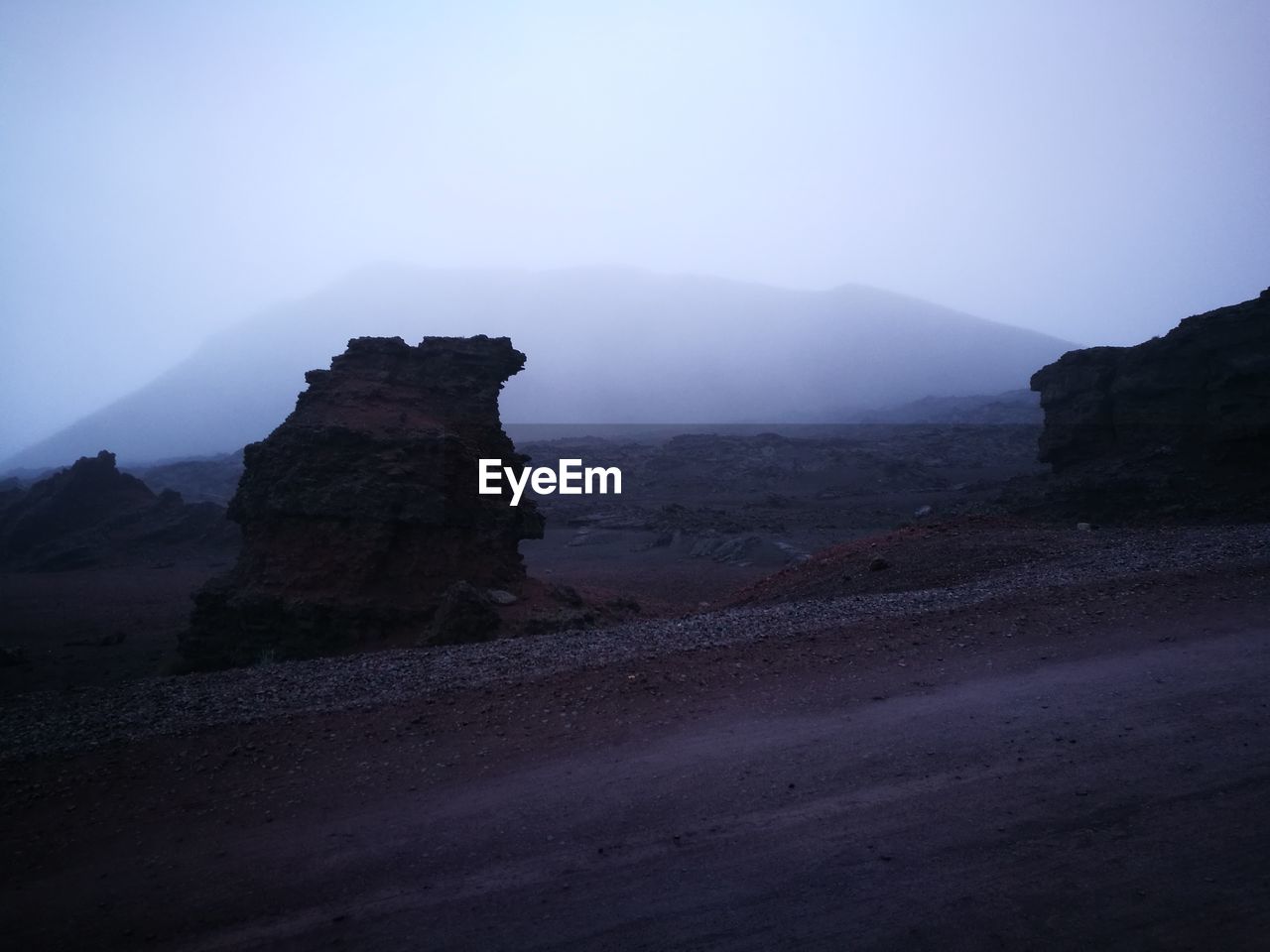 Rock formations on landscape against sky