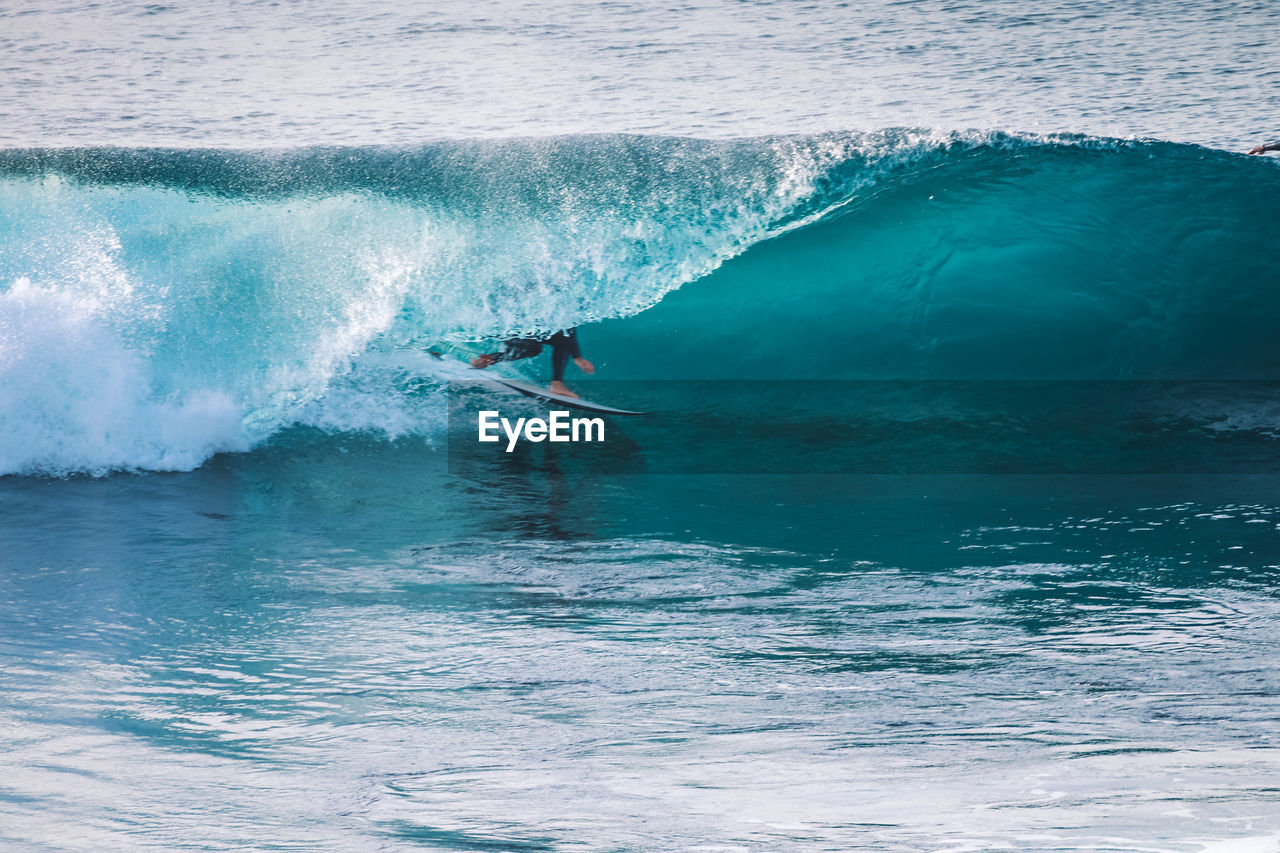 Surfer in a perfect barrel wave