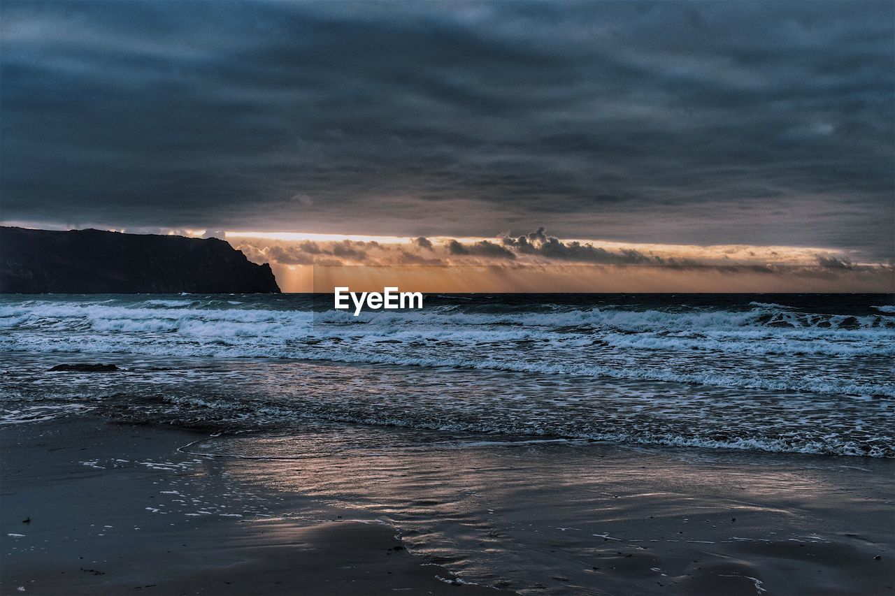 Scenic view of sea against dramatic sky