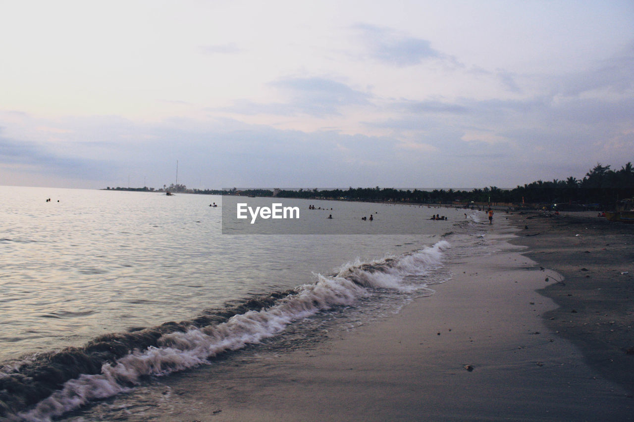 Scenic view of beach against sky during sunset