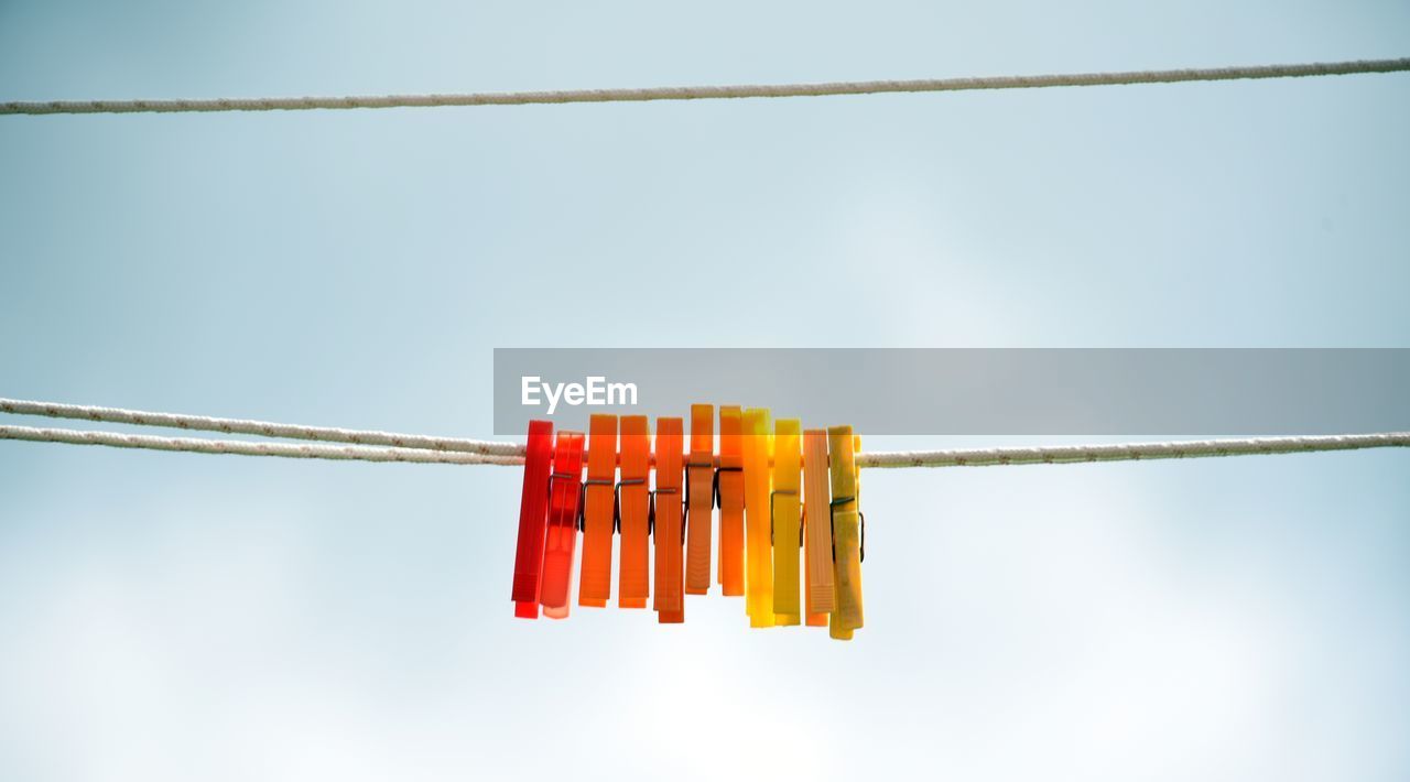 Low angle view of red flags against sky