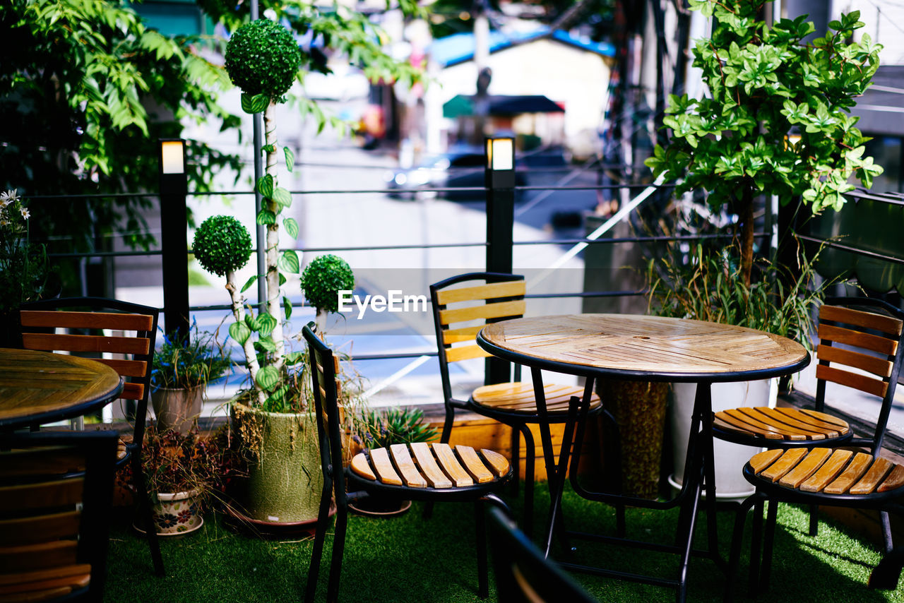 Empty wooden tables and chairs arranged at restaurant