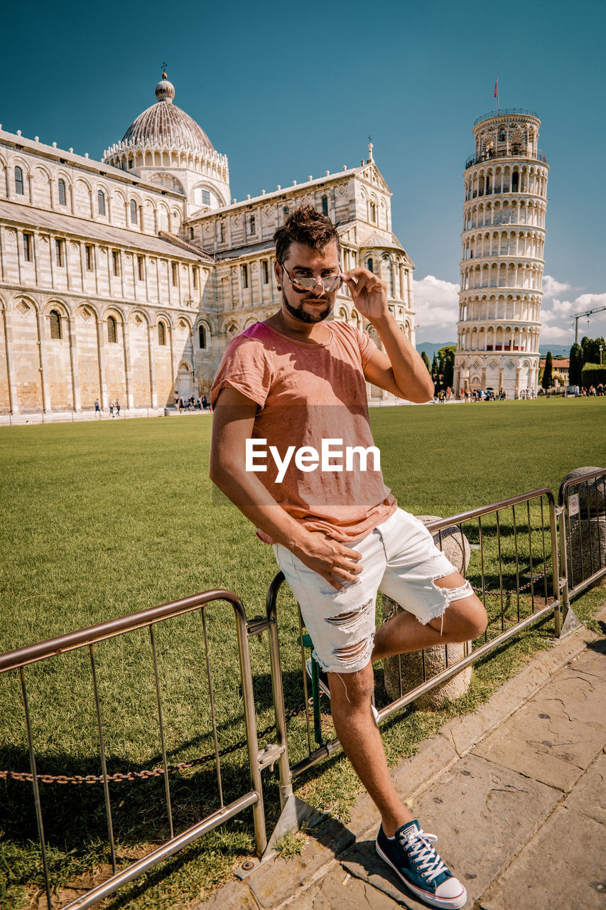 Man standing against leaning tower of pisa