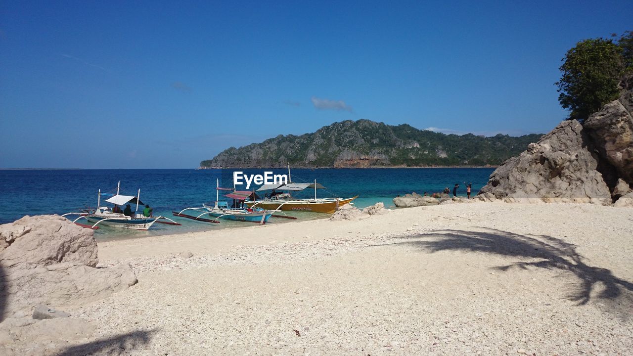 Scenic view of beach against blue sky