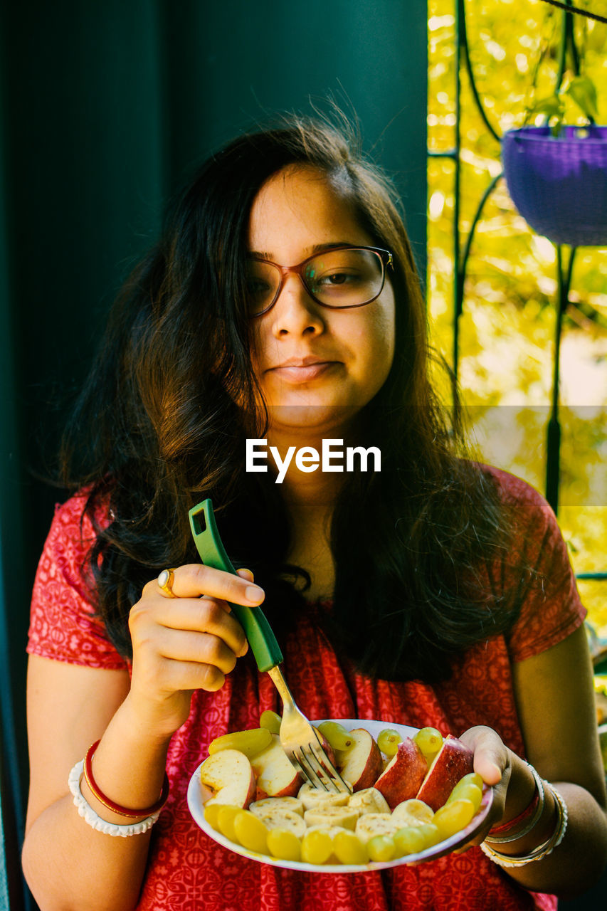 Portrait of young woman eating food. women need quality food for diet.