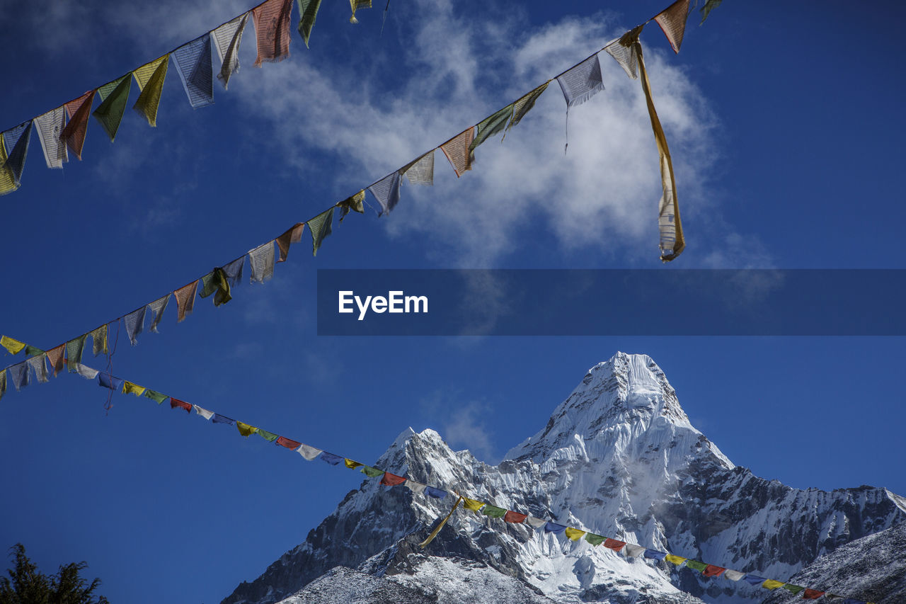 Prayer flags beneath ama dablam, near the trail to everest base camp