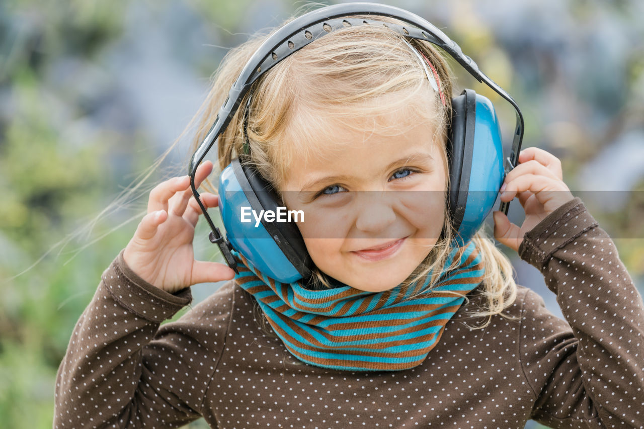 Portrait of smiling girl wearing headphones